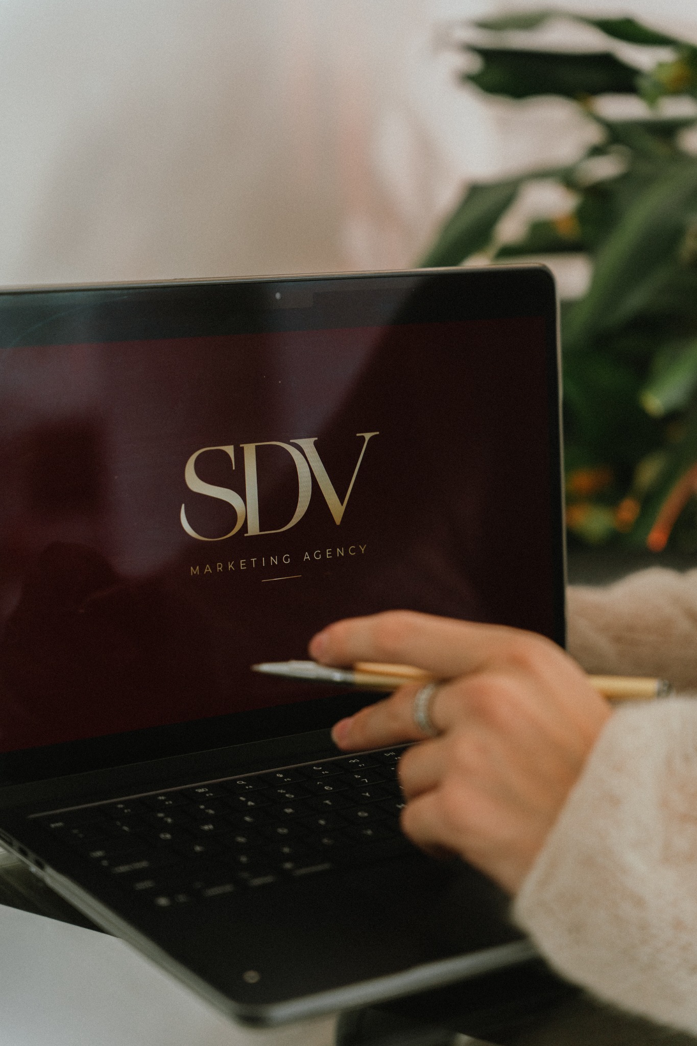 SDV Marketing Agency branding on a laptop during a planning session